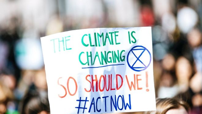 Poster with the text "the climate is changing: So Should we! Act now